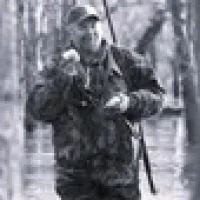 women and older man in the front lawn trees behind them