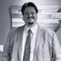 women and older man in the front lawn trees behind them